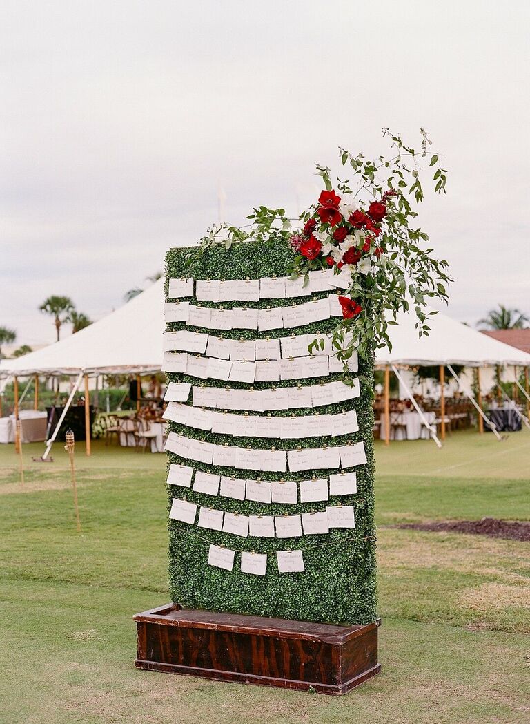 Escort card display on boxwood hedge