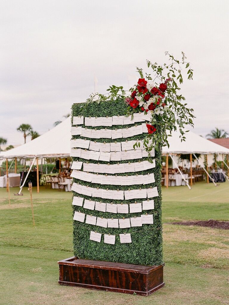 Escort card display on boxwood hedge