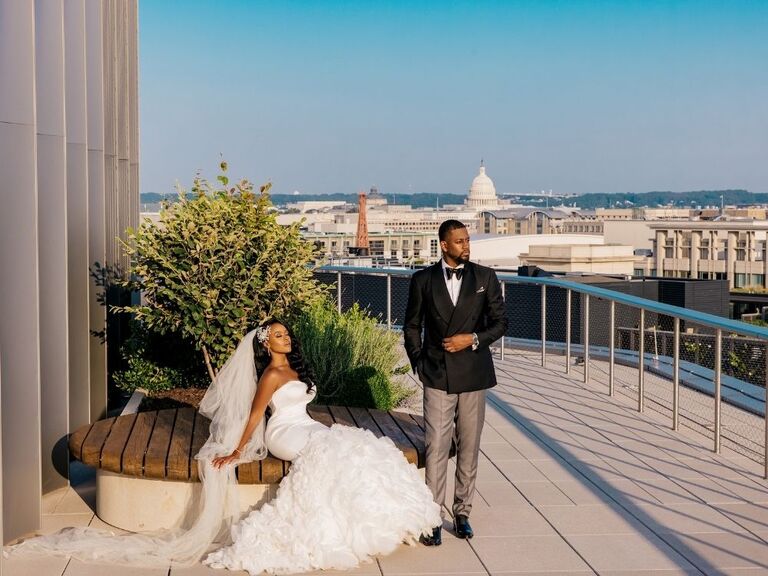 couple on rooftop with Capitol in background