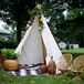 This time, the couple acknowledged Mike’s Passamaquoddy heritage in their decor. The couple had a teepee-inspired tent complete with lush colorful flowers from Belovely Floral and Event Design along the grounds. Pink garden roses, fern leaves, feathers and orange poppies all topped the decoration. To give the design a more bohemian flair, they surrounded it with yoga blankets, chic wicker furniture and matching vases of fern leaves.