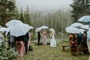 Bride and Groom, Officiant, Guests Holding Clear Umbrellas During Rustic Outdoor Mountain Ceremony