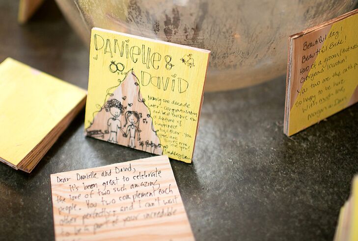 In lieu of a classic guest book, the newlyweds had their guests write their well wishes and advice (or playful illustrations) on painted wooden tiles.