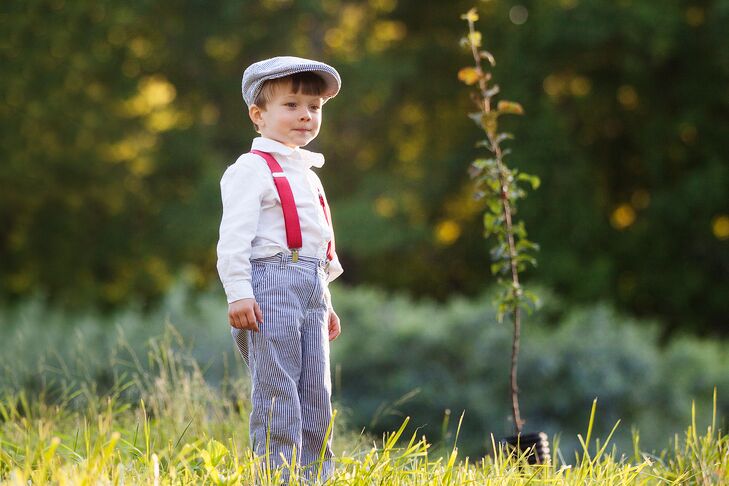 Adorable Ring Bearer with Red Suspenders and a Matching Newsboy Cap