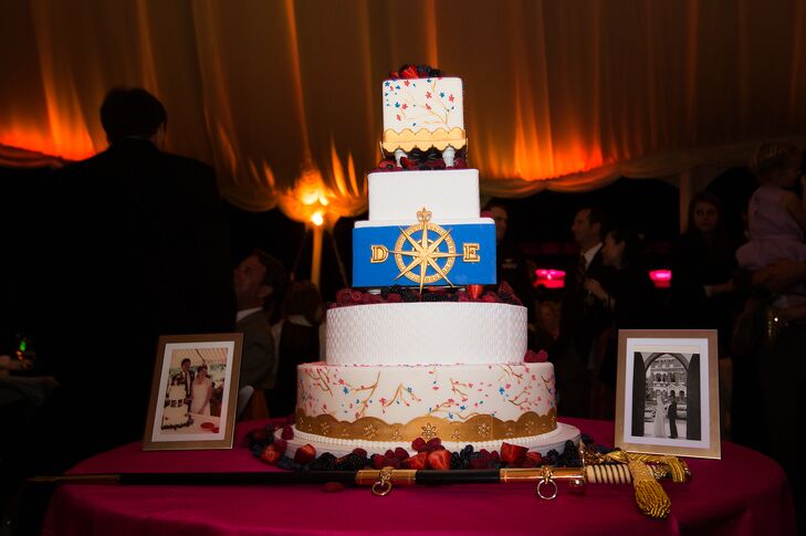 In keeping with the fresh fruit theme, the five-tiered wedding cake was topped with fresh berries. A gold scalloped base and white fondant pearls. The couple's monogram decorated the middle cobalt blue layer and a gold scalloped base contrasted with a white basket weave pattern.rn
