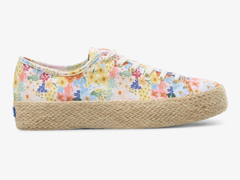 Platform sneaker with colorful florals, white laces, and a cotton canvas