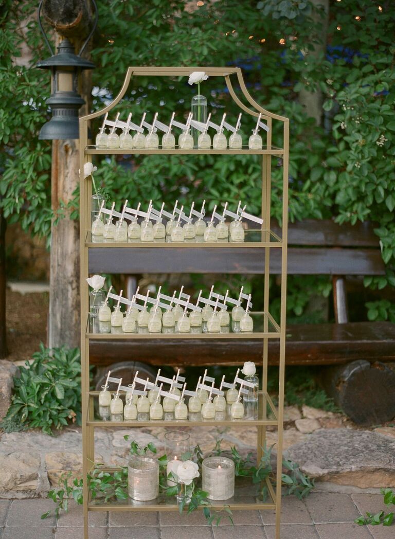 Mini bottles of tequila as escort cards on metal shelf