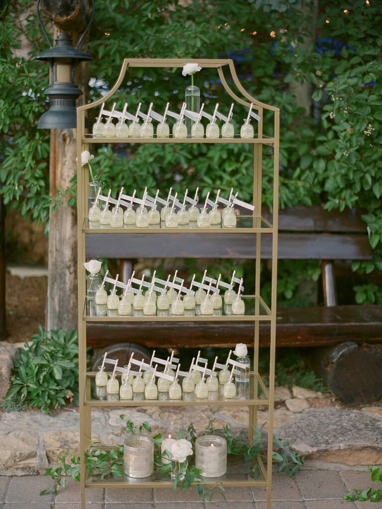 Mini bottles of tequila as escort cards on metal shelf