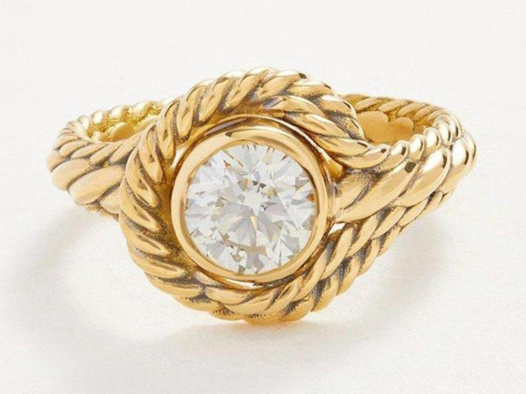 Braided thick gold band and round cut diamond in center