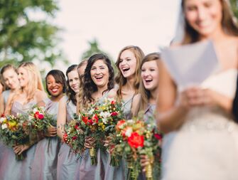 Bridesmaids laughing at ceremony vow exchange