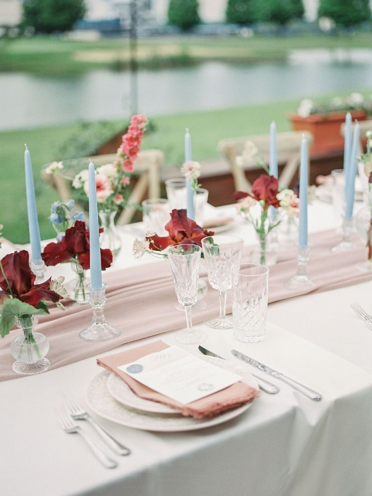 blue taper candles as wedding decor at garden wedding