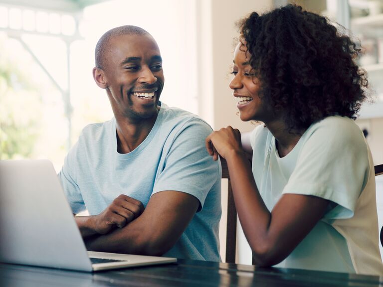 Couple looking at budget on computer