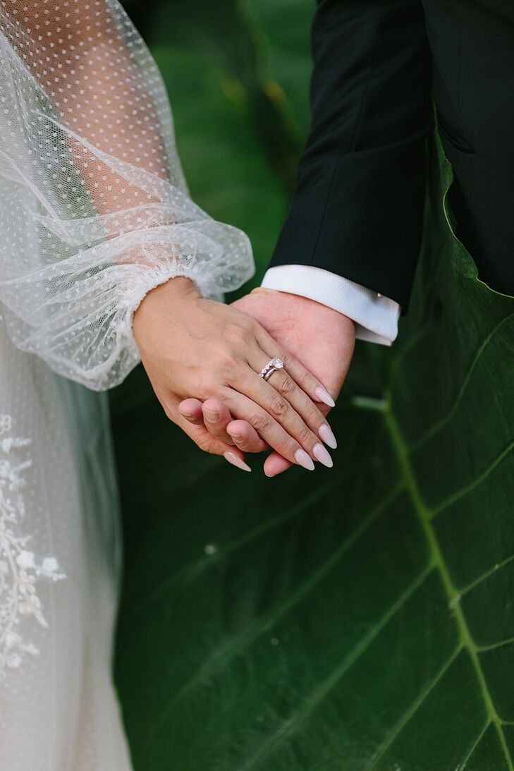 Bride With Long, Pink Nails Holding Groom's Hand With Ring