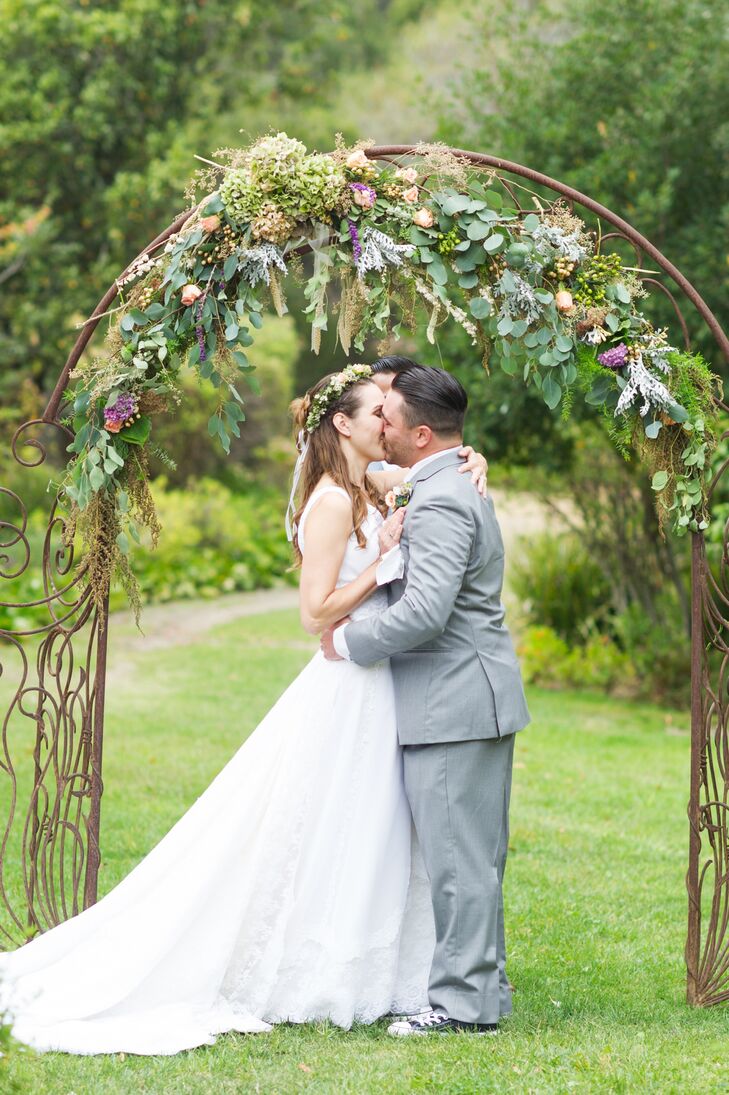 Danielle's cousin Roxana Napoli called upon her skills as a floral designer to help personalize all the day's floral decorations, one being the couple's wedding arch, which incorporates fragments of fabric from Danielle's mother's wedding gown.
