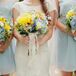 The dominant yellow and blue bouquets had flowers of hydrangeas, roses, craspedia and other blooms and greens making up the arrangement. The bridesmaids held the same bouquet, minus a long white lace ribbon wrapped around the stems of Katy's.
