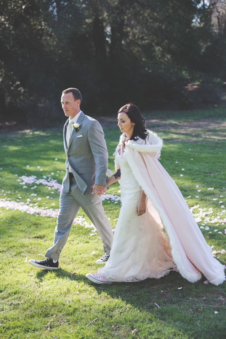 The couple walked while holding hands outside, with Sarah wearing a long blush fur cloak.