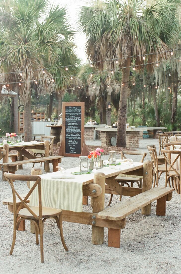 To fit the rustic location of Lesley and David’s Lowcountry oyster roast, burlap linens with an embroidered bright coral and pink chain pattern were draped over picnic tables. Colorful florals in turquoise vases decorate and guests sipped out of starfish- and coral-etched stemware.