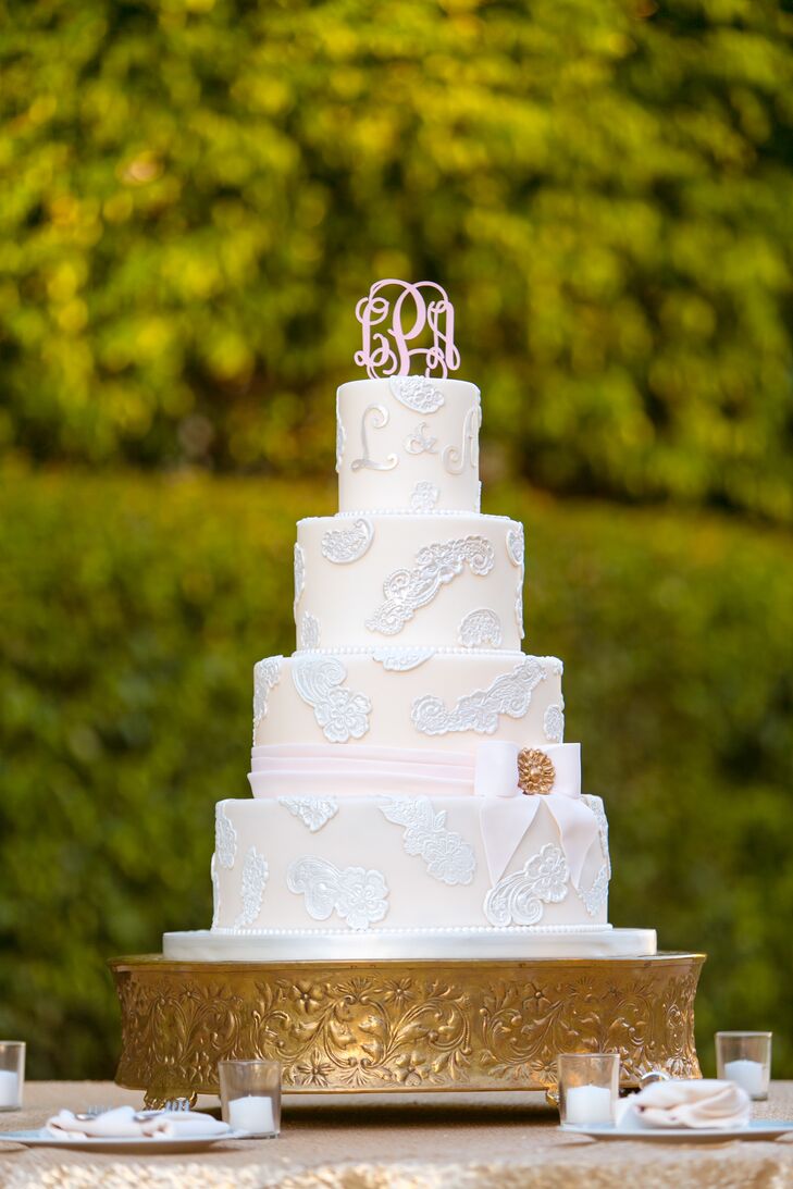 Kakes by Karen used a picture Lauren gave them for inspiration and came up with a sweet design. Every layer was decorated in lace-inspired details and ivory fondant. They also had a custom pink monogram topper that matched their monogrammed piping on the smallest tier. Instead of one flavor, Lauren and Andrew picked three. They had lemon, chocolate and carrot cake, separated by either vanilla, caramel or peanut butter buttercream frosting. Yum!