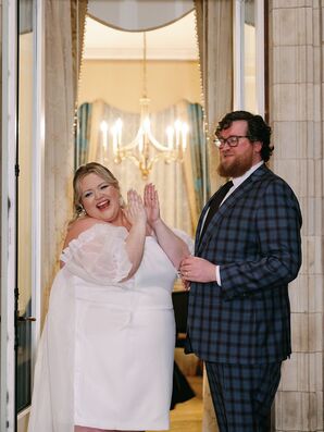 Bride in Mini Dress and Puffed Sleeves and Groom in Blue Checkered Suit Clapping