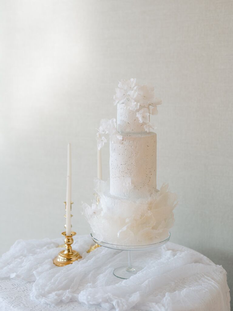 2023 wedding cake trend modern white wedding cake with crackled white buttercream and sugar flowers