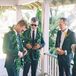 Grooms in Green Suits Putting on Their Greenery Leis Before Their Maui, Hawaii, Wedding