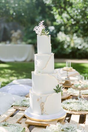 Four-Tier Cake With Gold Accents and Leaves
