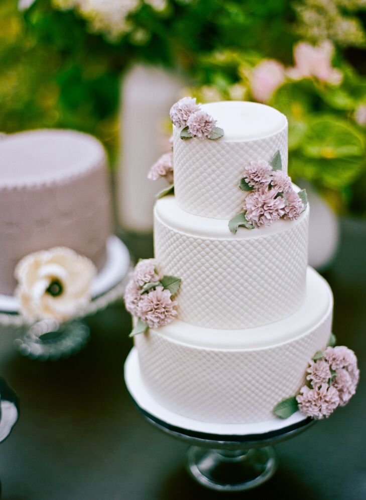 The elegant cake had a cushioned fondant pattern and muted blush florals gave it an artful appearance.