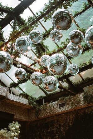 Custom Disco Ball Chandelier Installation With Hanging Greenery, Lights Over Loft Dance Floor