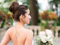 Bride wears her hair in an elegant top knot. 
