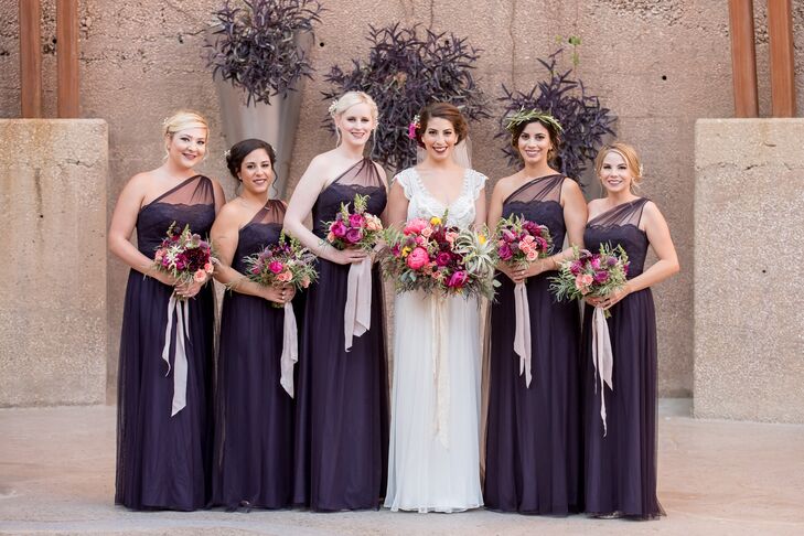 Jenna's Amsale bridesmaid dresses were long and elegant, matching the look of her gown. "My dress had beautiful beaded detailing at the top, with delicate lace sleeves, a low back and a cathedral-length veil," Jenna says of her Anna Campbell gown. The flowers in her hair matched the bouquets.