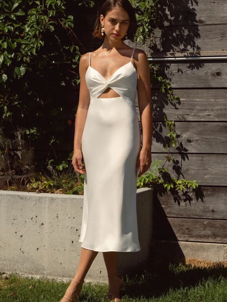Model wears an elegant silk slip dress. 