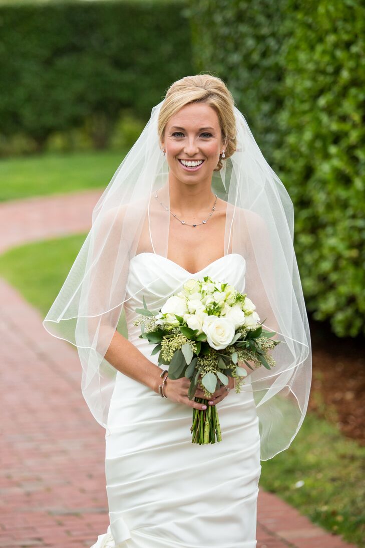 Following tradition, Alexandria added a fingertip-length blusher veil to her elegant updo for the ceremony.