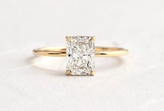 minimalist emerald engagement ring on gold band