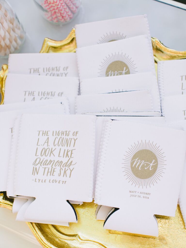 White and gold wedding koozies.
