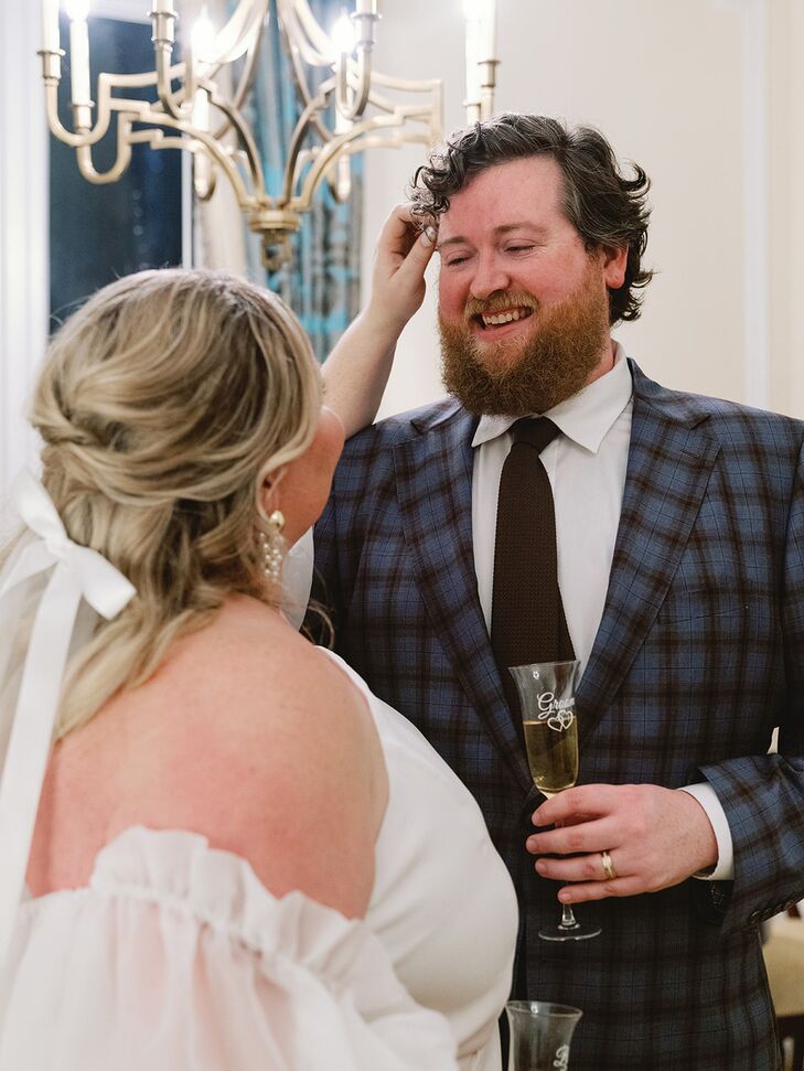 A Bride and a Groom in a Plaid Blue Suit With Champagne Laughing