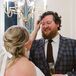 A Bride and a Groom in a Plaid Blue Suit With Champagne Laughing