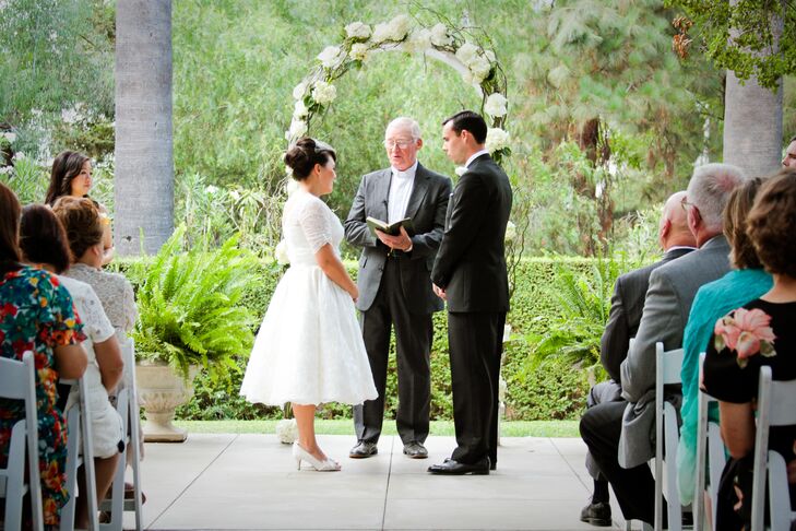Brandy and John stood on the patio at the Lindley-Scott House as their officiant conducted their ceremony. Brandy wore an ivory dress adorned with a skirt in a ball-gown style on the wedding day, while John wore a vintage-inspired black tuxedo.