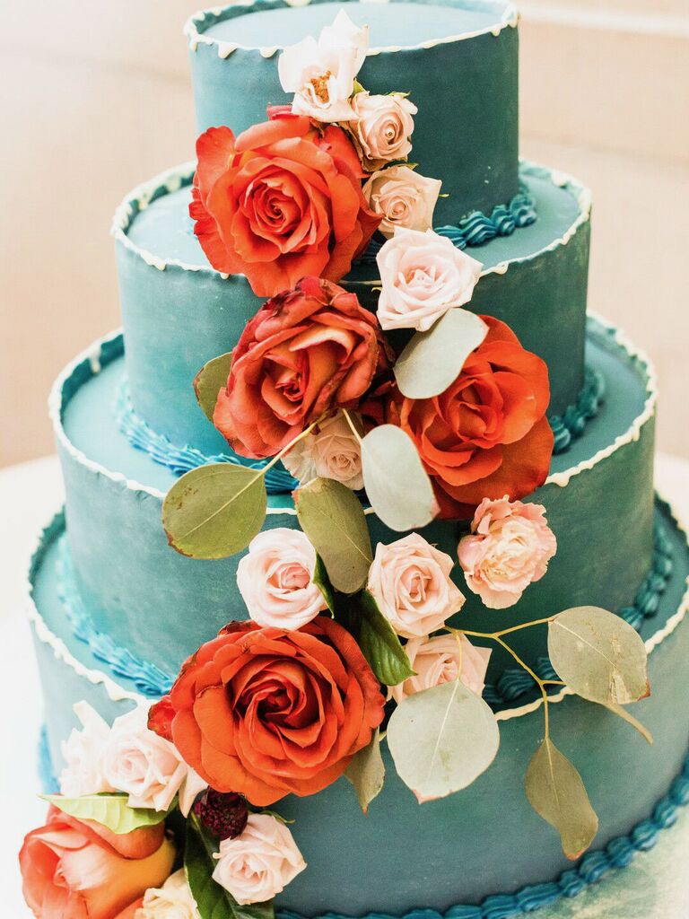 teal wedding cake with orange and light pink cascading roses