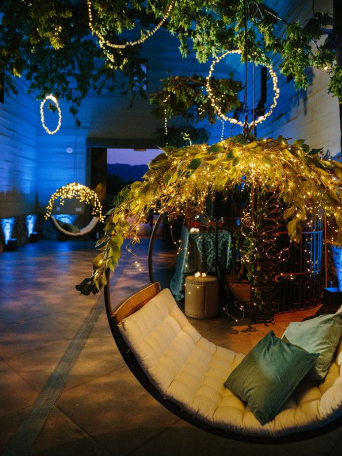 Hanging chairs with twinkle lights at reception