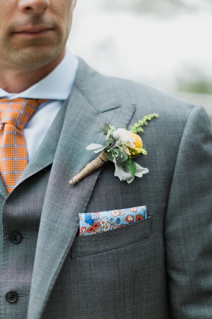 It was all about retro patterns for Jason's tie and floral pocket square, both in bright hues including orange, red and blue. His boutonniere continued the natural palette of green, white and yellow, set against his light gray suit.