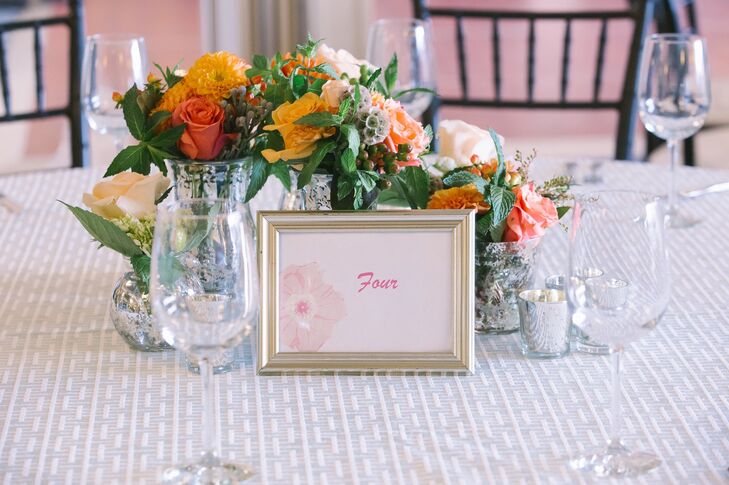Simple framed table numbers were decorated with a print of a single tropical flower.