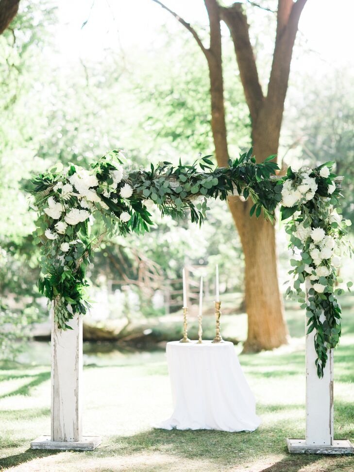 Michelle and Derik exchanged vows under a wooden arch adorned in flowers in a patch of trees overlooking a creek. “I loved this shaded area and how the sun would come through the trees,” Michelle says. “It was a very romantic site.” Michelle kept the ceremony decor simple, letting the natural beauty of the woods shine at Spirit Ranch in Lubbock, Texas.