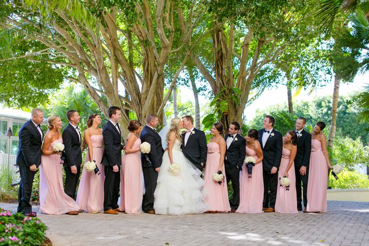 With such a cute palette of navy, blush, gold and ivory, it was almost too hard for Lauren to choose a bridesmaid dress. Eventually, she found a classic chiffon look for every woman: floor-length, pink dresses by Donna Morgan. Each one came with a metallic silver belt that gave them a hint of sparkle.