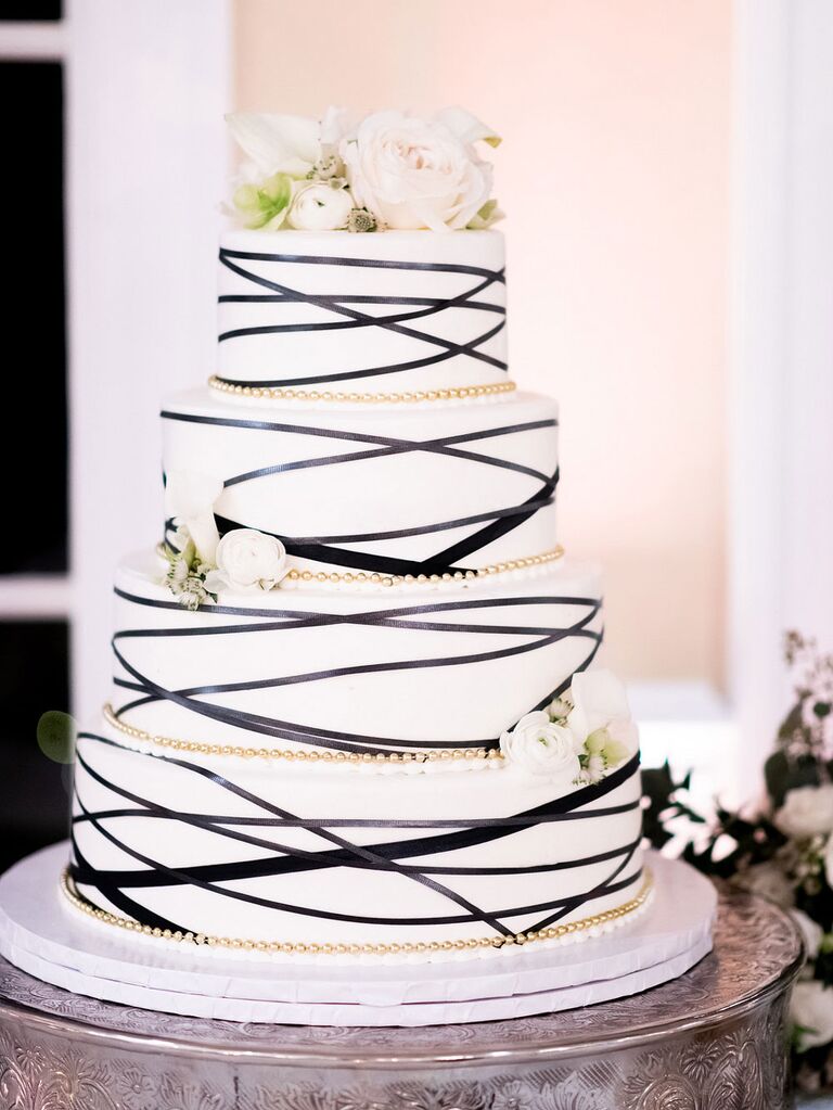 White wedding cake with black abstract lines and gold details