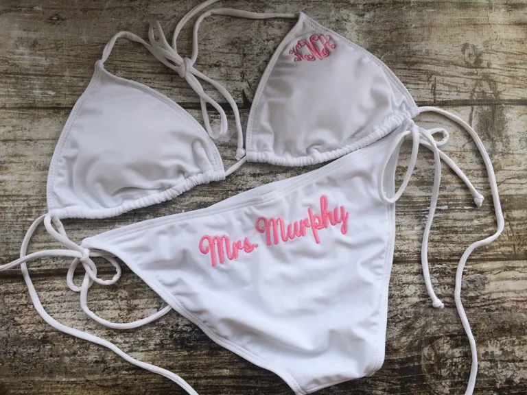 white bikini with monogram on top and 'mrs.' on bottoms