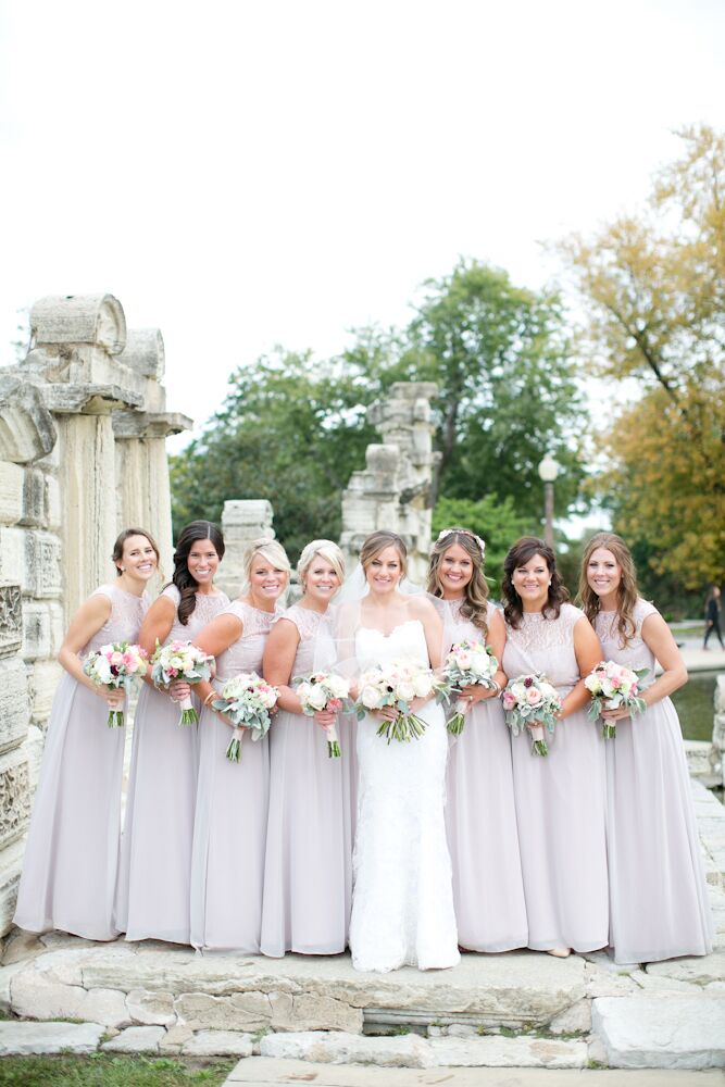 Jessica spent awhile looking for a light blush dress that would work with all her bridesmaids’ body types and the boho-chic theme. She found the perfect floor-length, illusion neckline dresses by Jim Hjelm at Hyde Park Bridal in Cincinnati, Ohio. She had each lady complete her look with beaded belts and vintage-style earrings.