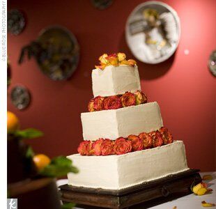Guests indulged in a three-tiered, square cake frosted with vanilla buttercream and decorated with fresh roses. Inside, layers of vanilla bean cake were filled with apricot and mocha.