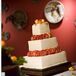 Guests indulged in a three-tiered, square cake frosted with vanilla buttercream and decorated with fresh roses. Inside, layers of vanilla bean cake were filled with apricot and mocha.