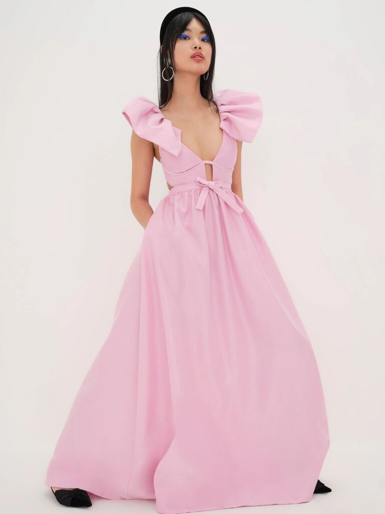 maximalist pink spring wedding guest dress with structured sleeves and full skirt