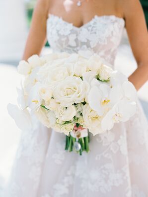 Bride Holds Structured Bouquet of While Garden Roses, Orchids and More