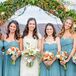 Pam's bridesmaids wore short, turquoise dresses with a strapless sweetheart neckline and ruched bodice. Each bridesmaid bouquet included neutral hues with pops of orange to evoke the fall theme.
